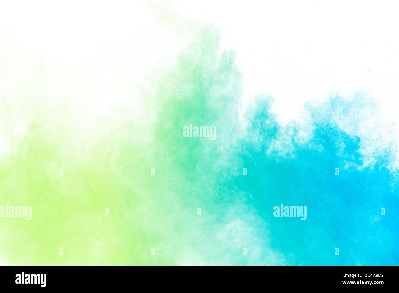 Abstract blue green powder explosion on white background.Freeze motion of blue green dust cloud. Stock Photo