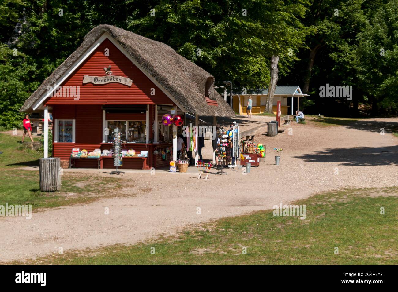 Ry, Denmark - June 16 2021: Grass area around Himmelbjerget near Silkeborg, Many people enjoy the good weather and picnics. The kiosk with souvenirs c Stock Photo