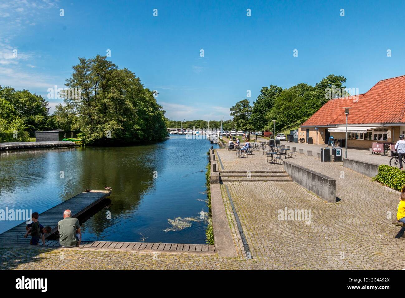 Ry, Denmark - June 16 2021: Ry Marina by Silkeborg, Beautiful marina with both in the background and people enjoying themselves on a nice summer day. Stock Photo