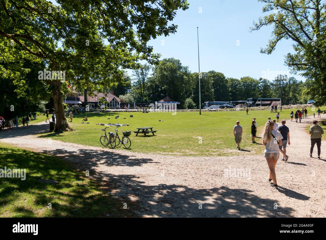 Ry, Denmark - June 16 2021: Grass area around Himmelbjerget near Silkeborg, Many people enjoy the good weather and picnics. The kiosk with souvenirs c Stock Photo