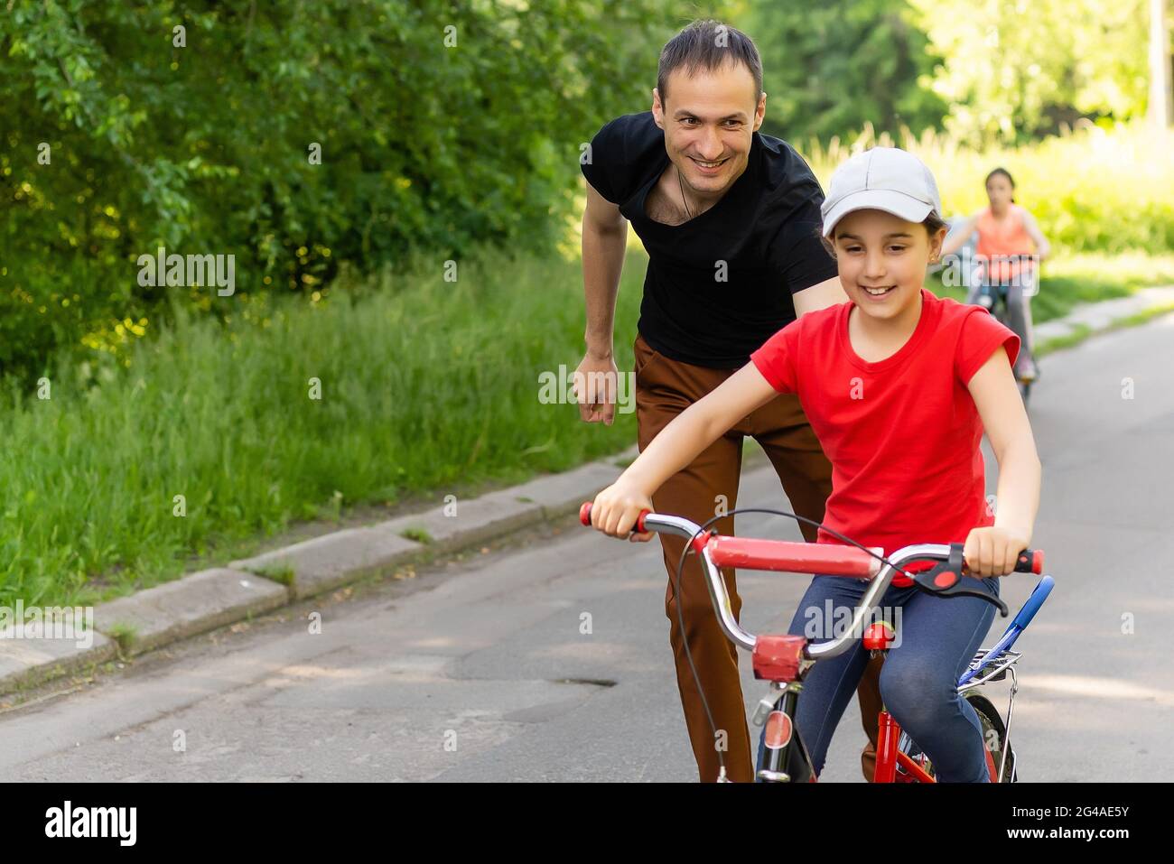 girl learning to ride a bike