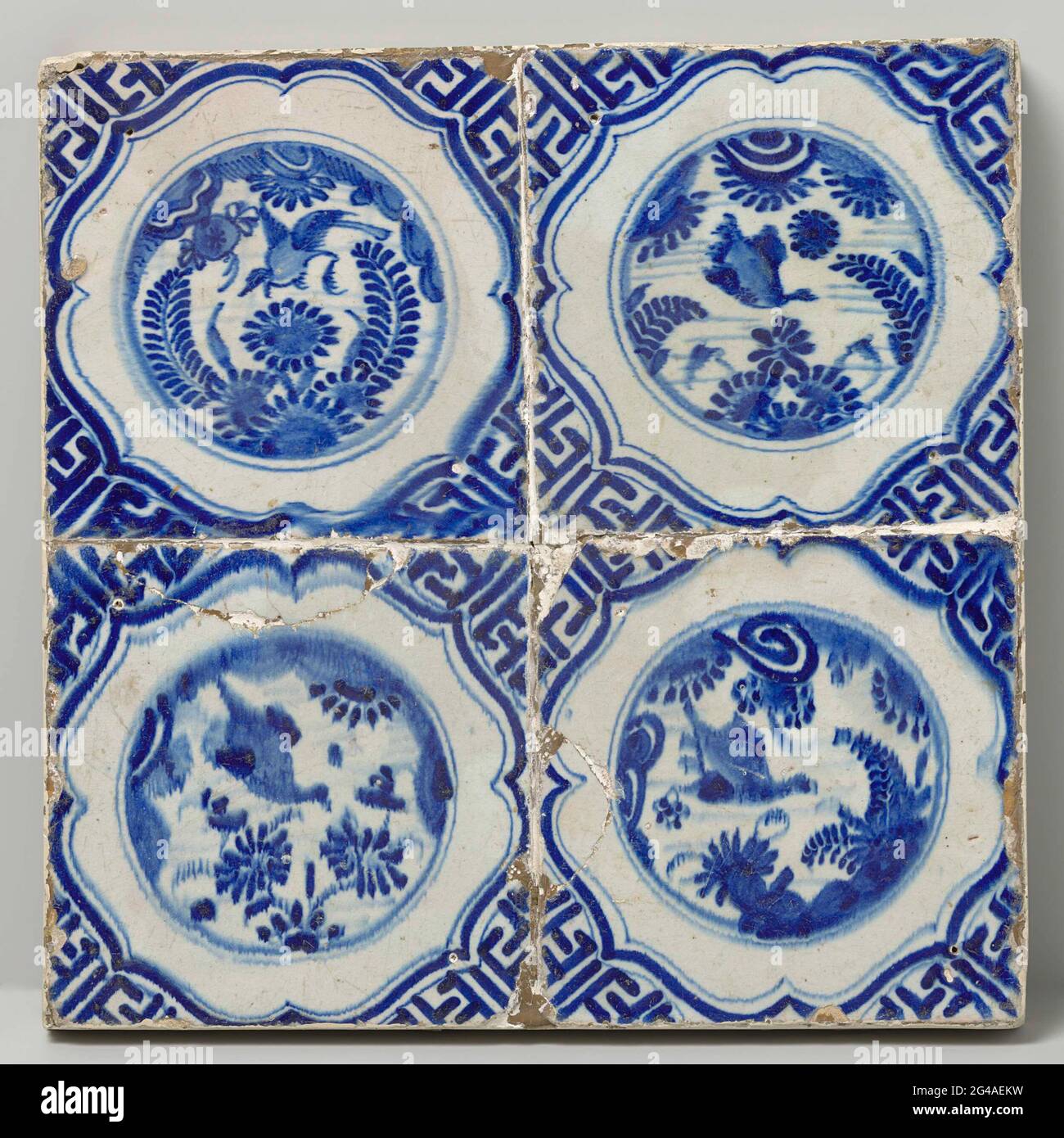 Field of four tiles with birds. Four tiles field (2 x 2) each with a blue  painted bird in a Chinese garden inside a circle surrounded by a brace. In  the corners,
