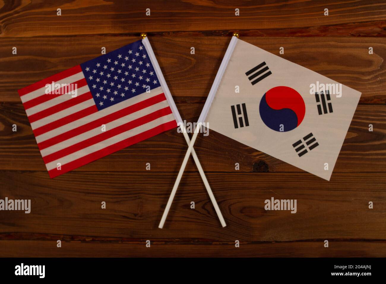 Flag of USA and flag of South Korea crossed with each other. USA vs South Korea. The image illustrates the relationship between countries. Photography Stock Photo