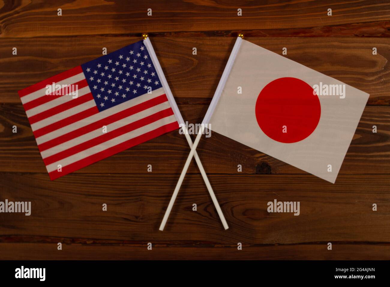 Flag of USA and flag of Japan crossed with each other. USA vs Japan. The image illustrates the relationship between countries. Photography for video n Stock Photo