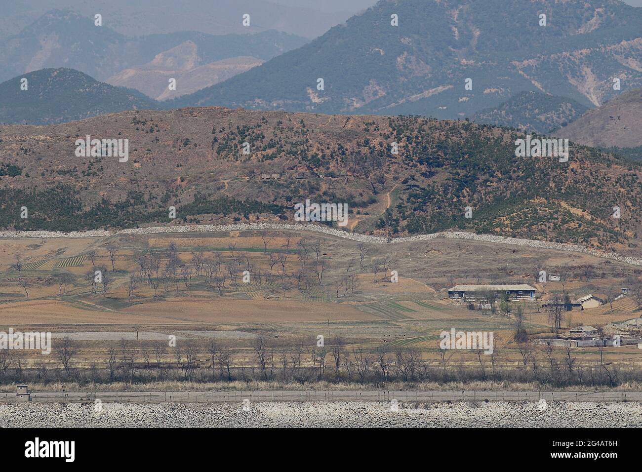 April 16, 2018-Ganghwa Island, South Korea-A View of North Korea Hwanghae Province One Village. View from Ganghwa Island border village. North Korean people are actively preparing for spring farming. The agenda for the third inter-Korean summit scheduled for April 27 is unlikely to have North Korean human rights issues despite calls for the inclusion by more than 200 NGOs earlier this week. Stock Photo