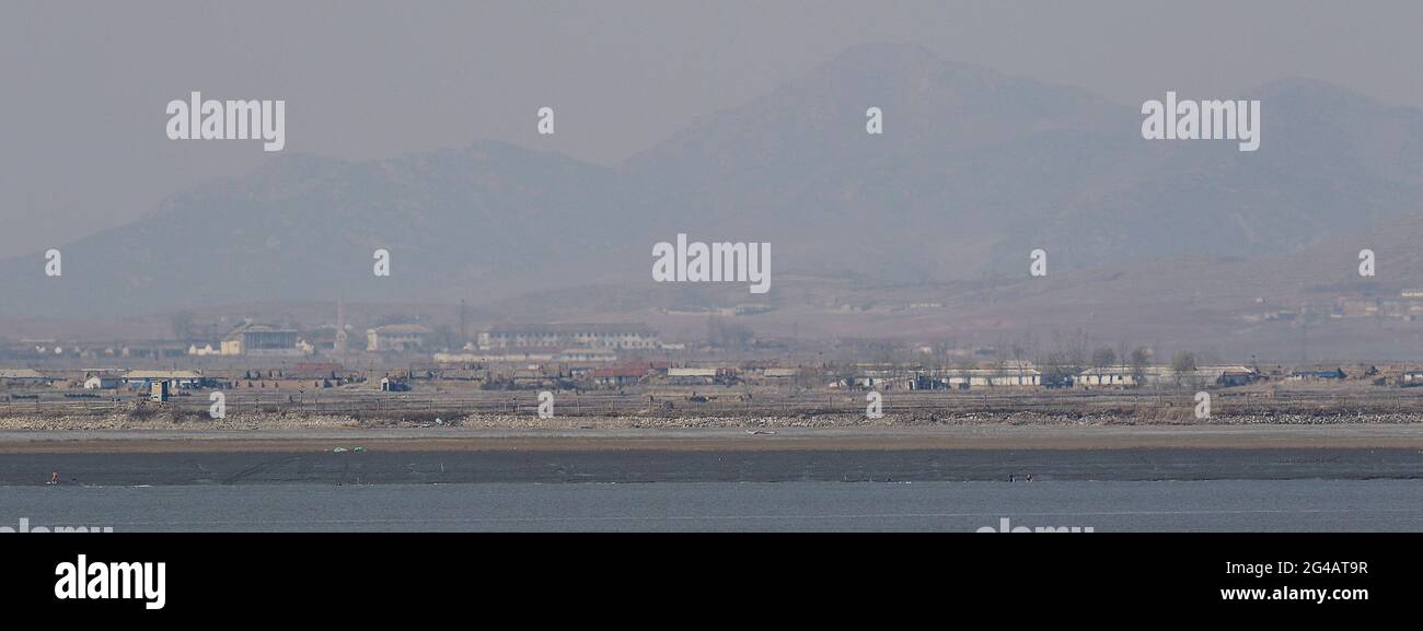 April 16, 2018-Ganghwa Island, South Korea-A View of North Korea Hwanghae Province One Village. View from Ganghwa Island border village. North Korean people are actively preparing for spring farming. The agenda for the third inter-Korean summit scheduled for April 27 is unlikely to have North Korean human rights issues despite calls for the inclusion by more than 200 NGOs earlier this week. Stock Photo