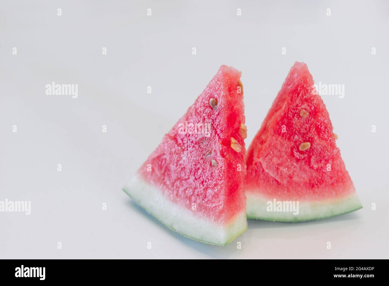 Slices of watermelon in the shape of a triangle on a white background ...