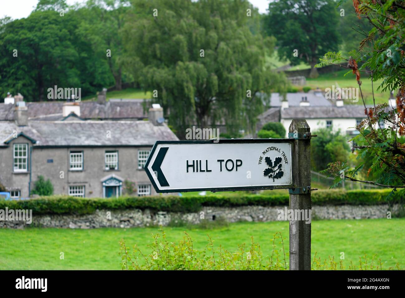 Sign Pointing To Beatrix Potters Hill Top Farm In The Village Of Near Sawrey In The Lake District Cumbria England UK Stock Photo