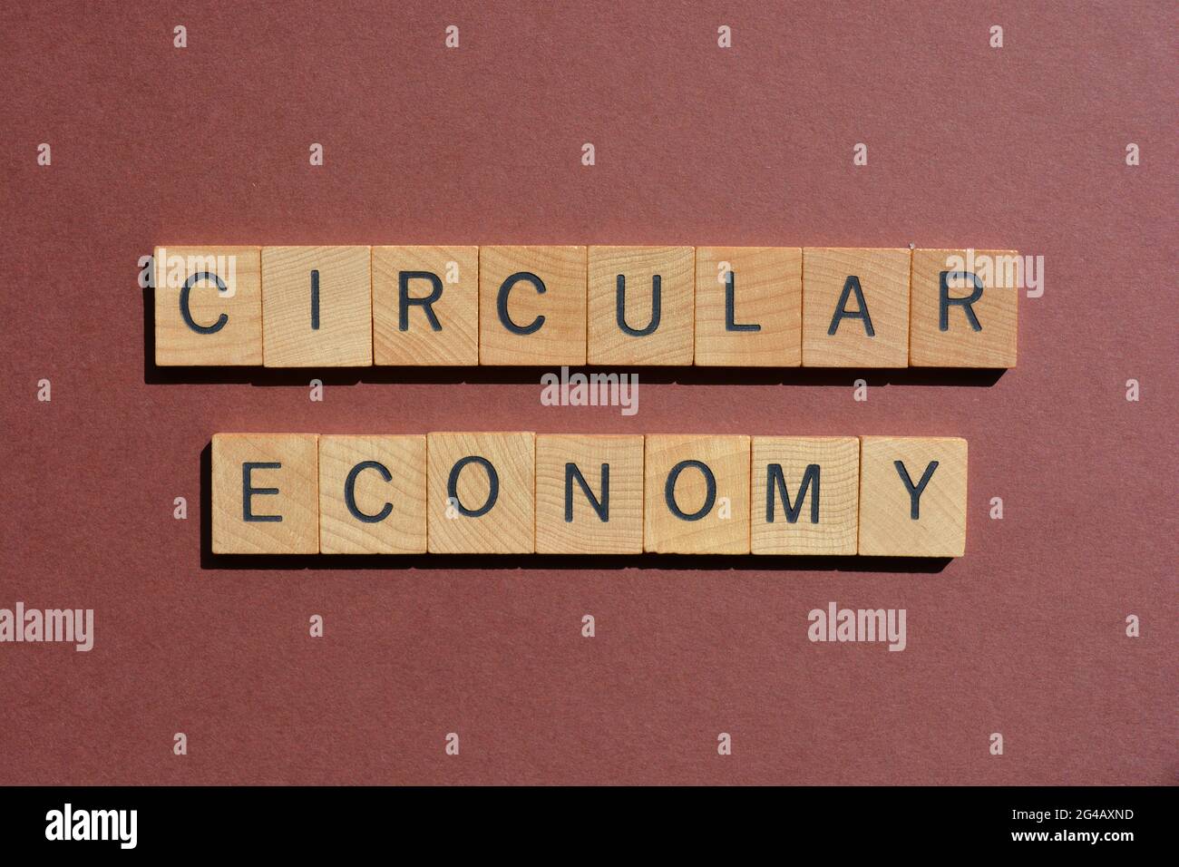 Circular Economy, words in wooden alphabet letters isolated on brown background Stock Photo