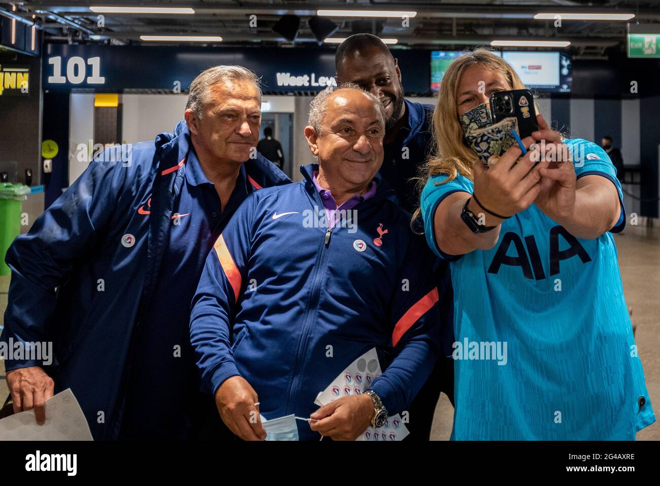 London, UK.  20 June 2021.  Former Spurs players (L to R) Gary Mabbutt, Ossie Ardiles and Ledley King pose with a woman after she received her Pfizer vaccine jab at a mass vaccination centre at Tottenham Hotspur stadium as the capital aims for 100,000 doses administered per day. Chelsea, West Ham and Charlton were other London football clubs who took part the previous day.  Credit: Stephen Chung / Alamy Live News Stock Photo