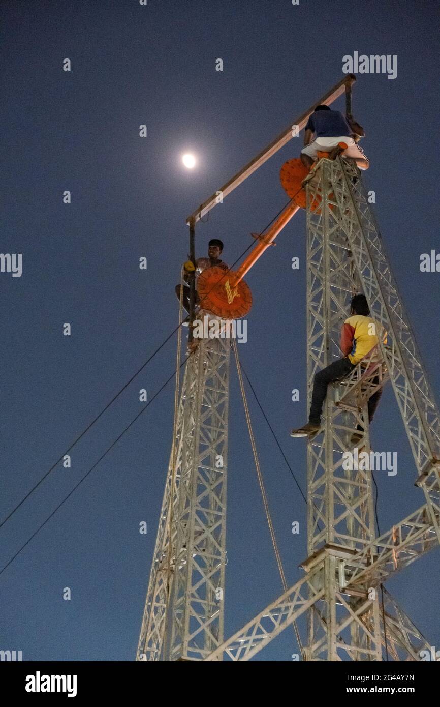 Workers dismantling various fair ground rides Stock Photo - Alamy