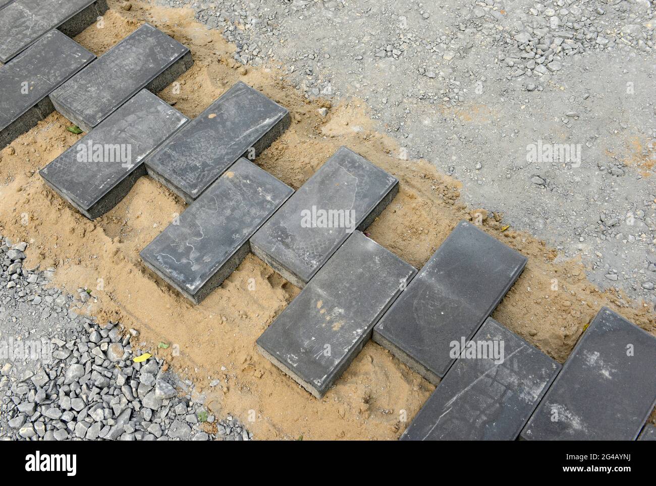 Paving stones laid alternately on a path in Tuanjiehu district of eastern Beijing during hard landscaping work. Beijing, China Stock Photo