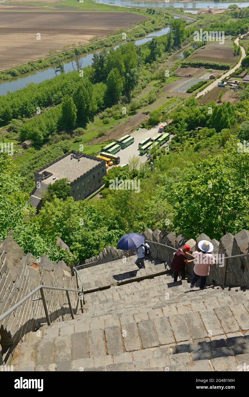 Visitors climb the steep steps of the great wall at Hushan on the