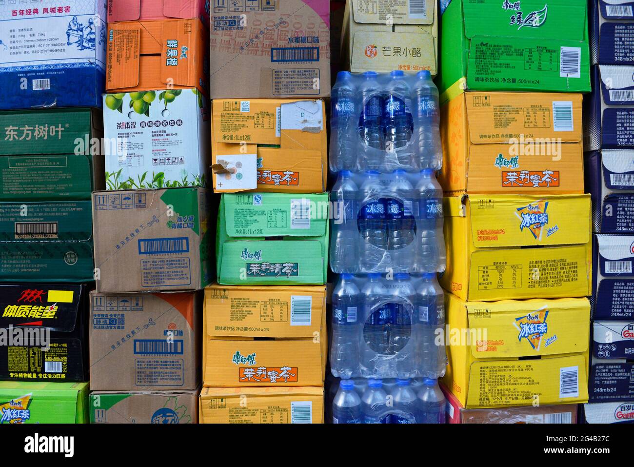 Many boxes of bottled drinks piled outside a convenience store in Dandong, Liaoning province, China Stock Photo