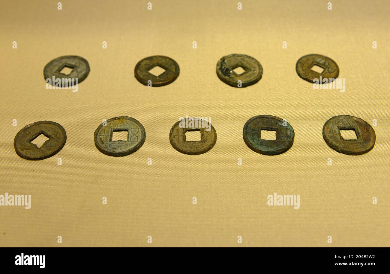 Traditional Chinese coins with a square hole in the centre on display