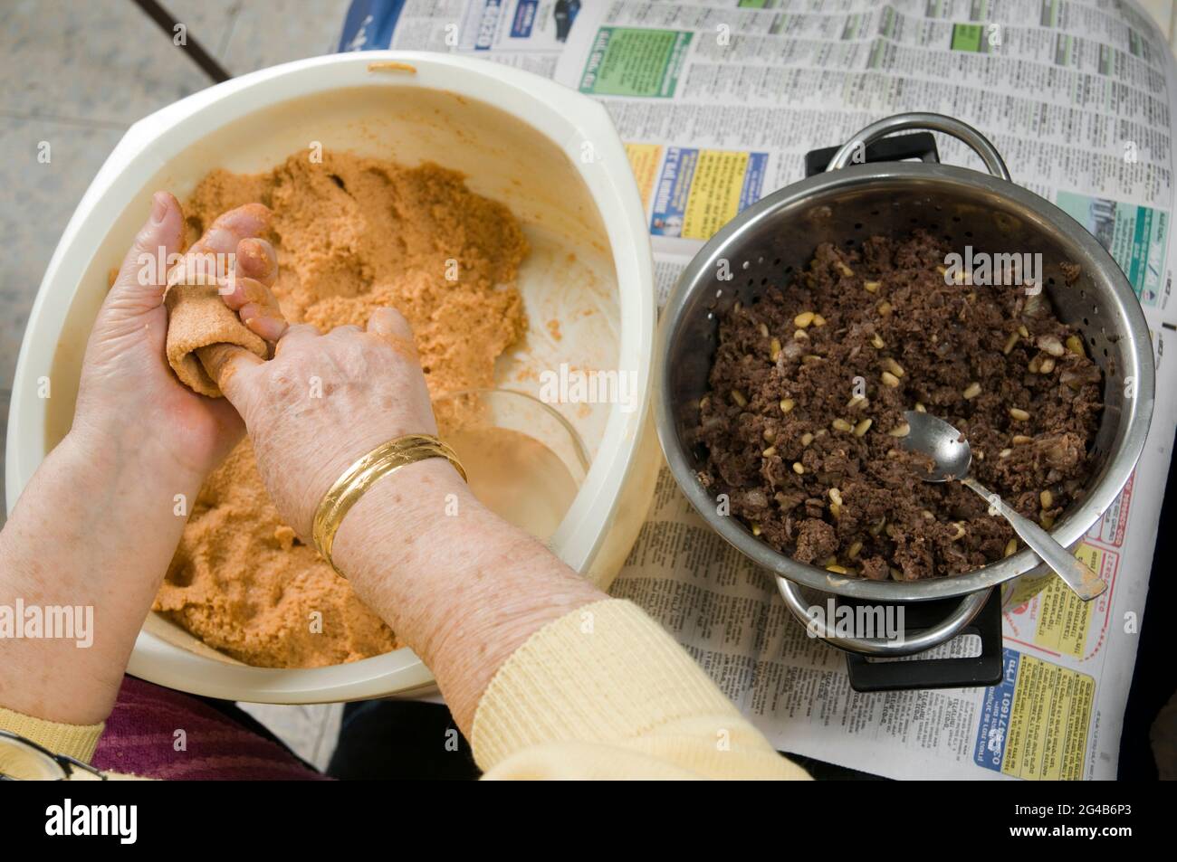 Preparing Kibbeh (Also Kibbe, Kubbah, Kubbeh) Burghul shell stuffed with chopped meat, onions and pine nuts. Preparing the elongated burghul outer she Stock Photo