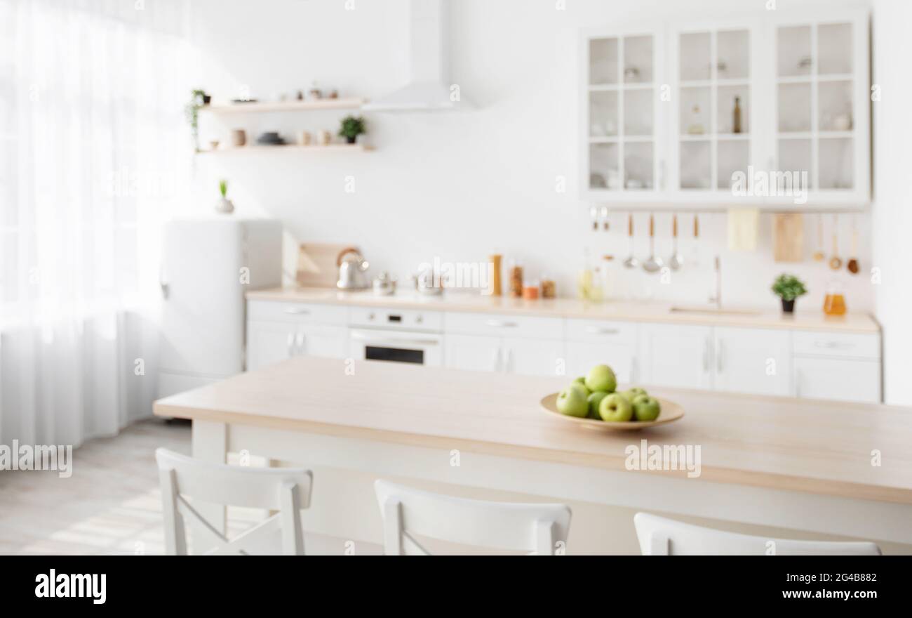 https://c8.alamy.com/comp/2G4B882/scandinavian-interior-of-kitchen-with-wooden-island-and-white-chairs-nearby-utensils-and-dishes-on-kitchen-furniture-2G4B882.jpg