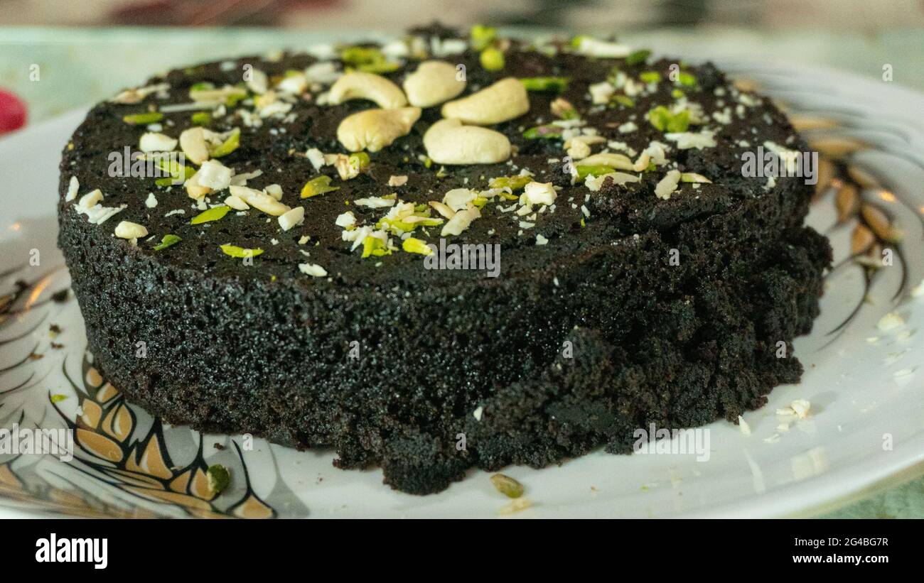 Biscuit cake with dry fruit filling decorated with cashew pistachios