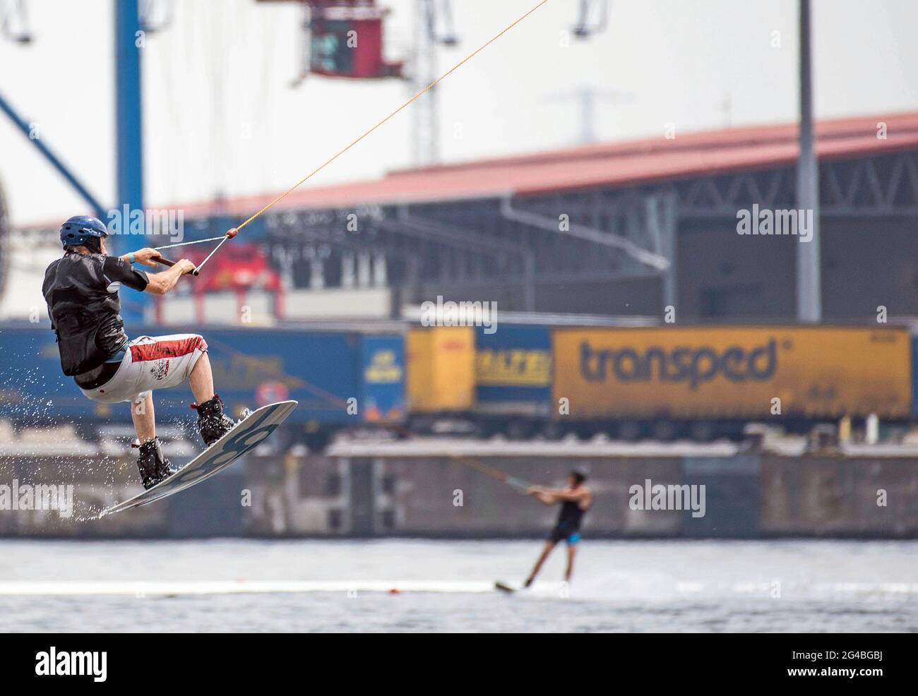 Rostock, Germany. 20th June, 2021. A wakeboarder jumps on the Warnow river at the IGA Park