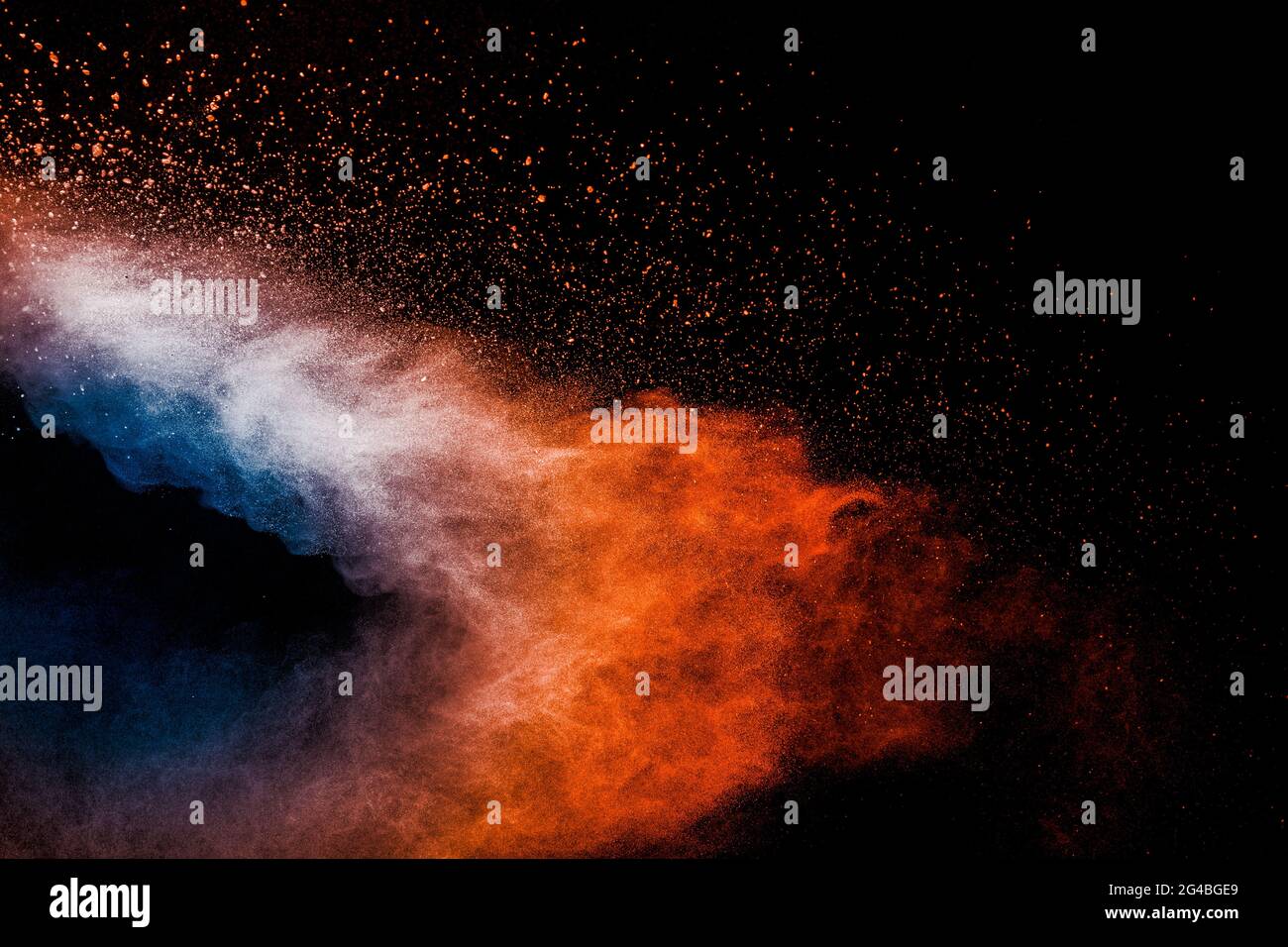 Orange blue  powder explosion on black background.Orange blue color dust splash clouds. Stock Photo