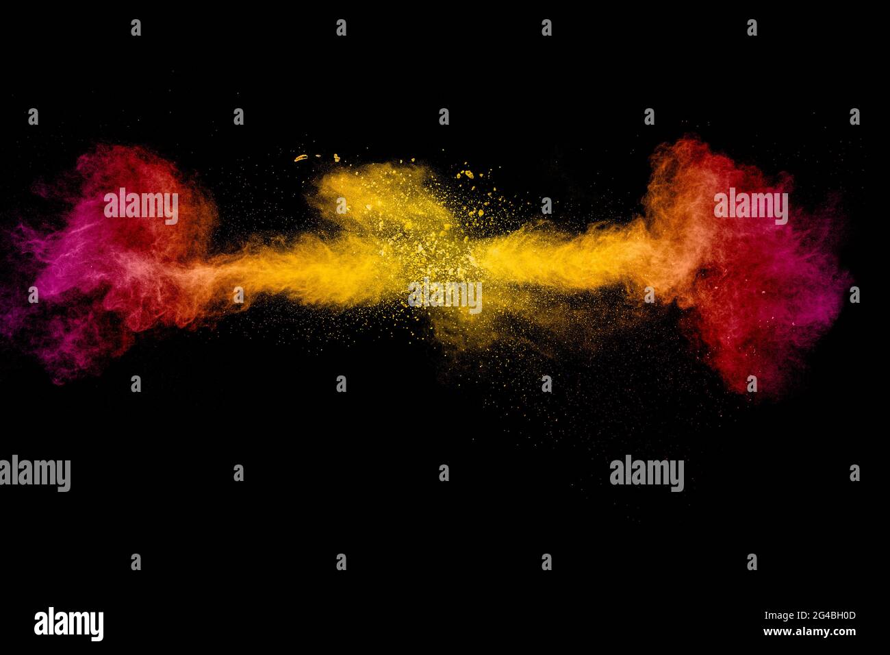 Abstract explosion of orange pink dust on black background.Freeze motion of orange pink powder burst. Stock Photo