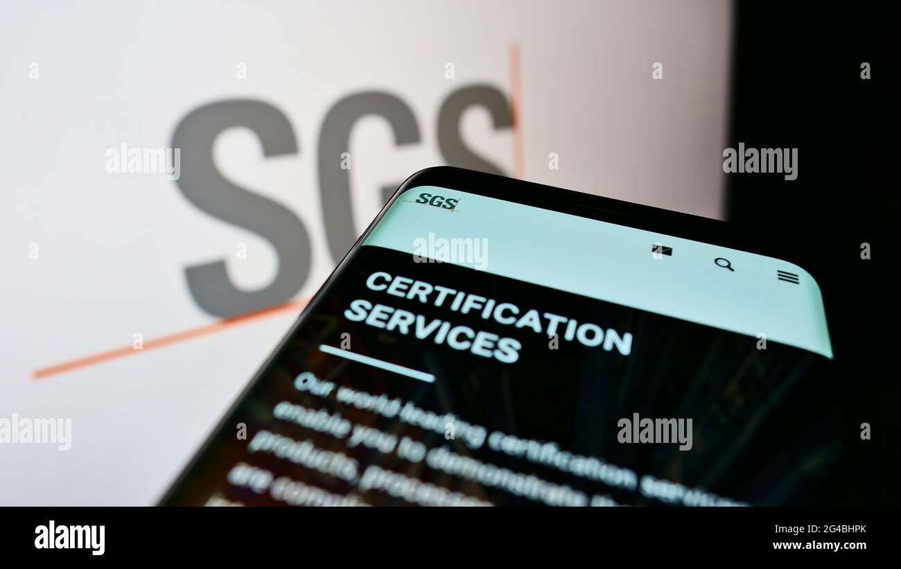 Mobile phone with webpage of Swiss certification company SGS S.A. on screen  in front of business logo. Focus on top-left of phone display Stock Photo -  Alamy