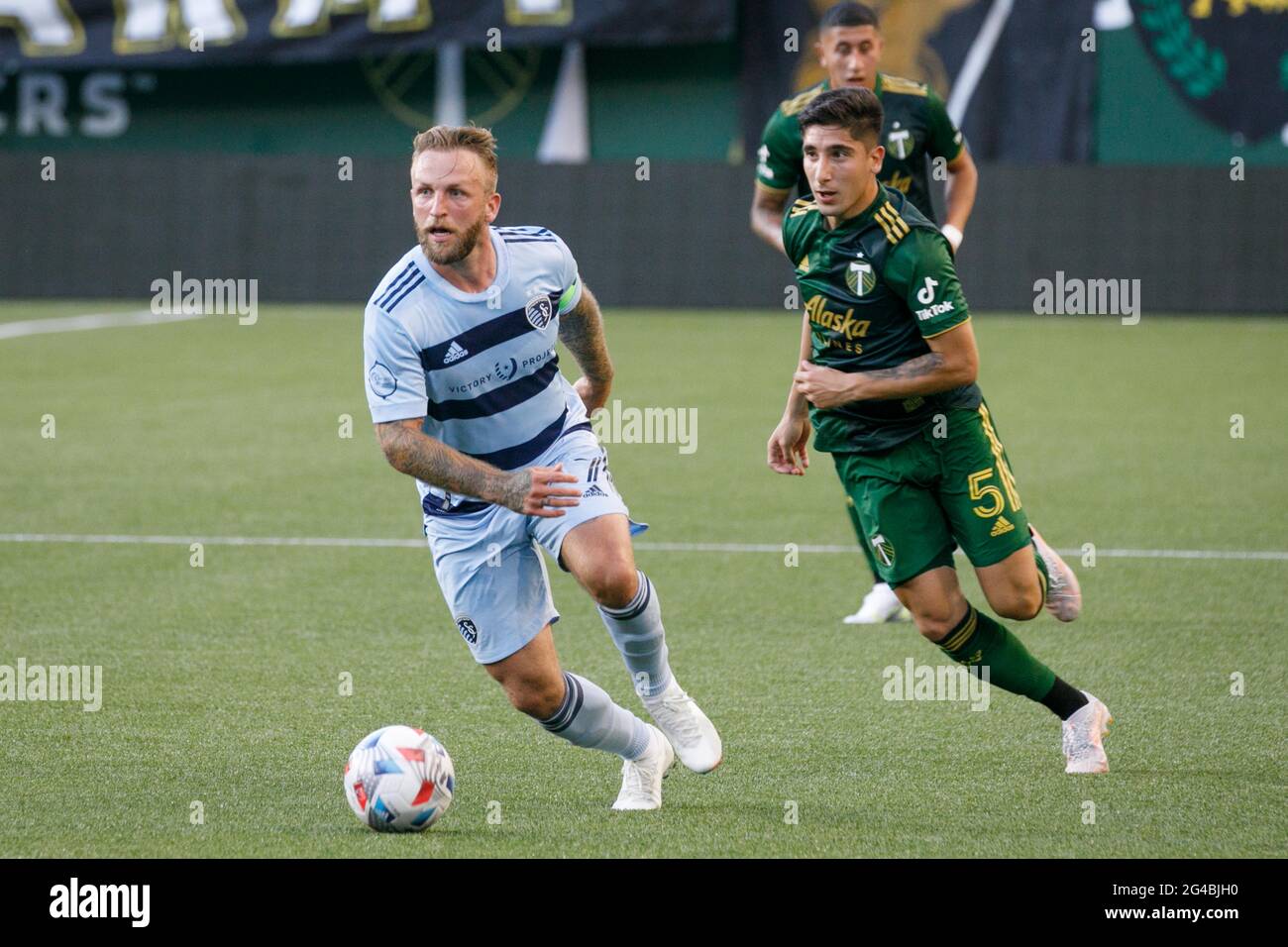 The Timbers' Claudio Bravo (R) chases down Johnny Russell. The Portland Timbers Football Club defeated Sporting KC (Kansas City) 2-1 at Portland, Oregon’s Providence Park on June 19, 2021, with a crowd for the first time allowed at 80% of capacity. Portland overcame an early 1-0 deficit with two first-half goals by Dairon Asprilla and Marvin Loria.  (Photo by John Rudoff/Sipa USA) Stock Photo