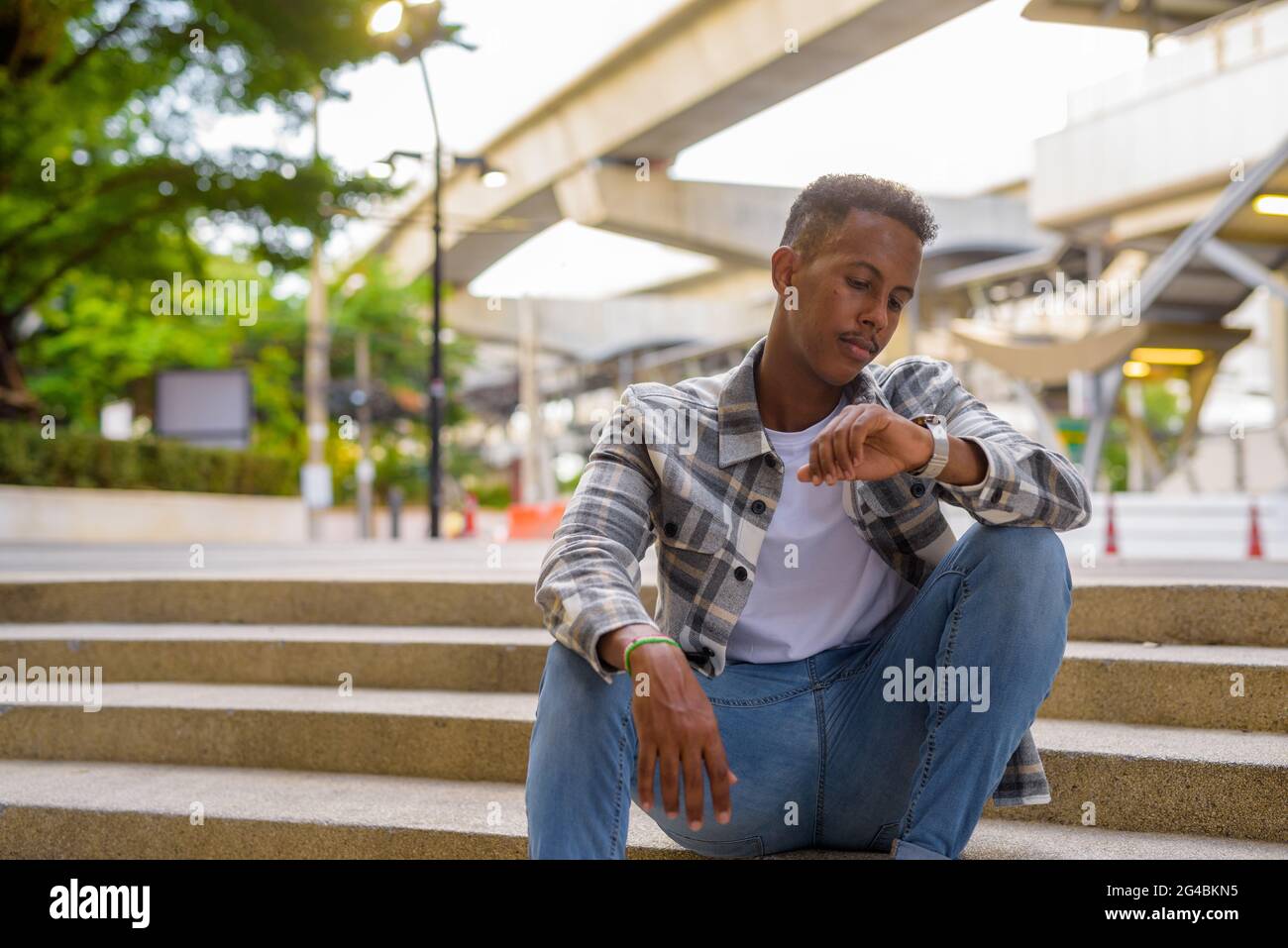 Waiting young african man checking hi-res stock photography and images ...