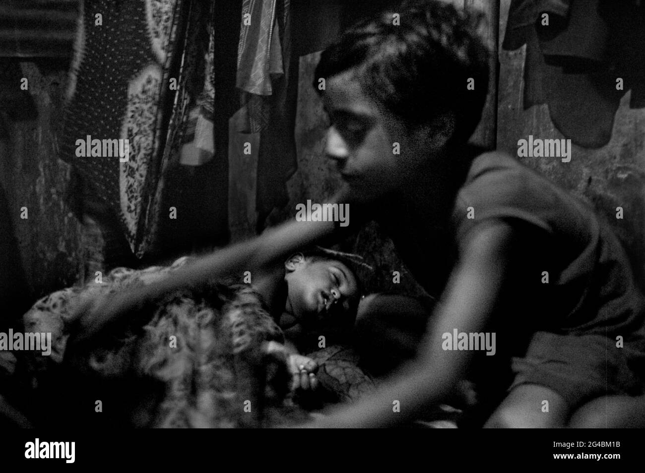 A baby nephew to look after when mother and sister-in-law aren’t around.  Dhaka, Bangladesh. May 2, 2007. Stock Photo