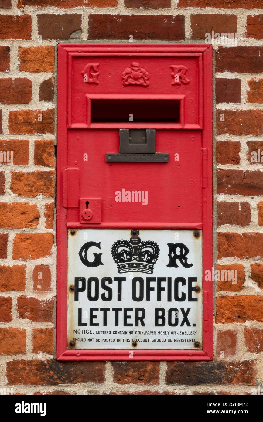 Post Office letter box from King George 5th set into a brick wall Stock Photo