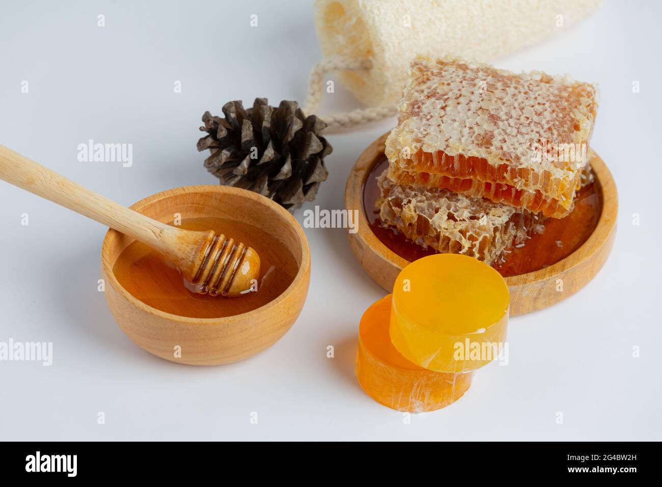 Natural skin care soap and serum with honey and honeycomb laid on white ...