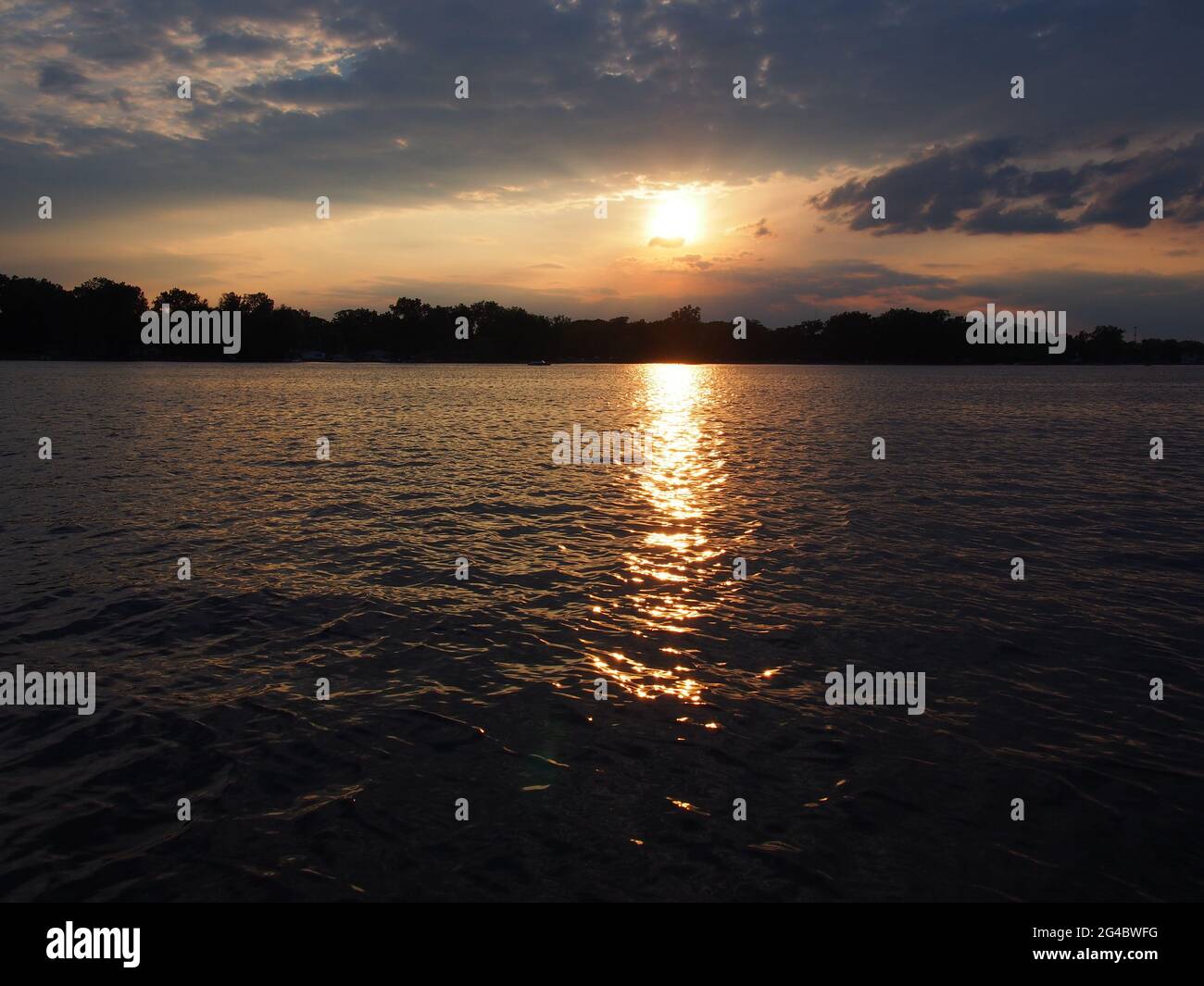 Lake Sunset Reflecting on Pontoon Boat on Lake Lansing in Haslett, Mi. USA Stock Photo