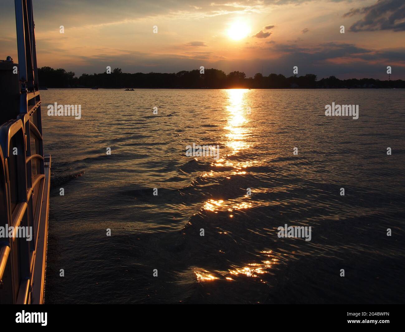 Lake Sunset Reflecting on Pontoon Boat on Lake Lansing in Haslett, Mi