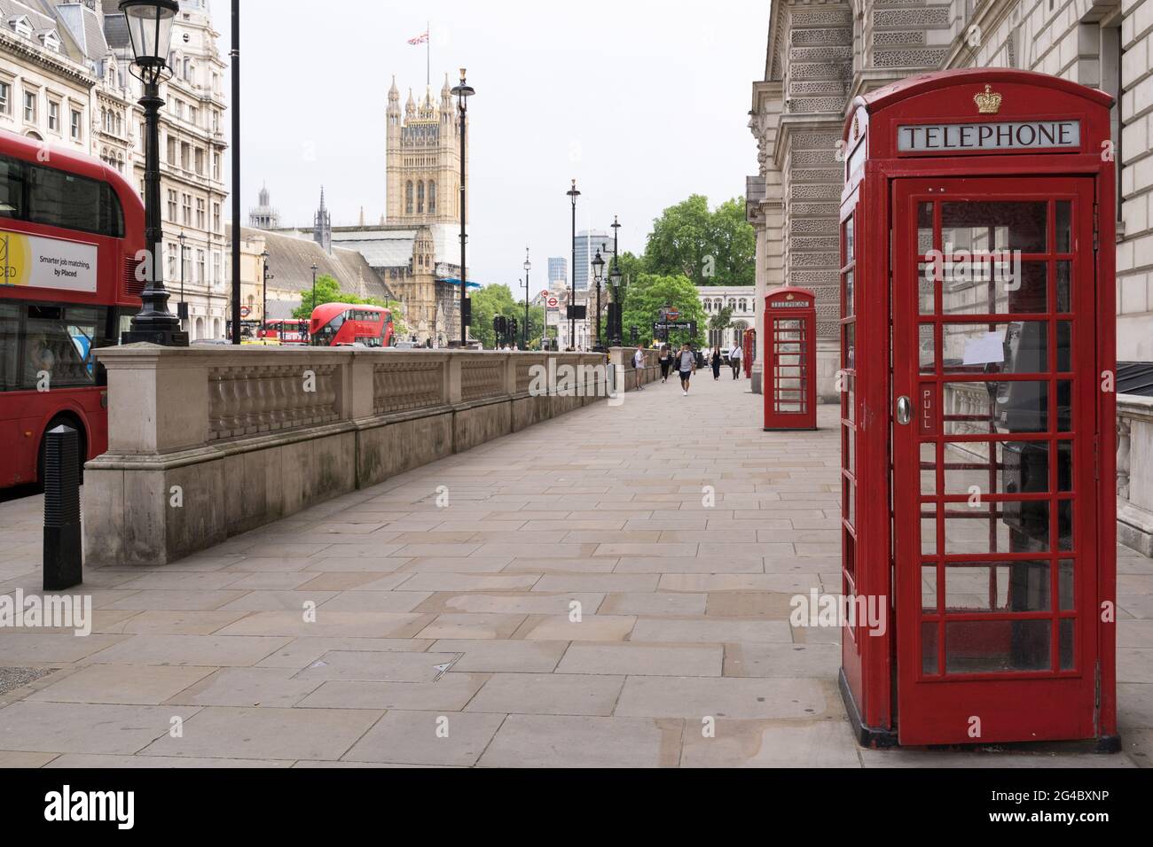 red telephone boot box on Whitehall, with house of Parliament in the background, union flag , England, UK Stock Photo