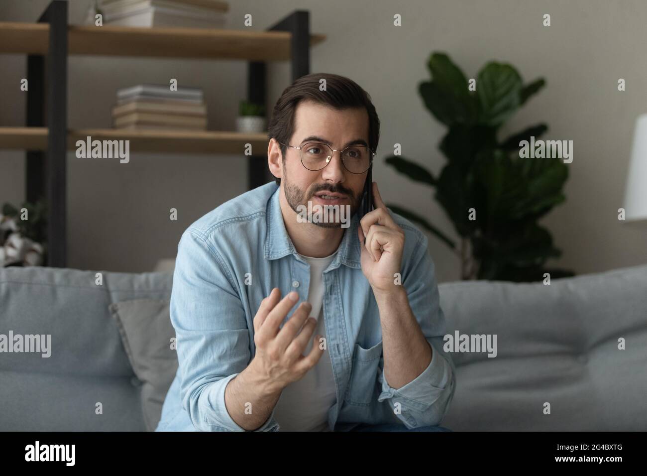 Happy young man holding phone call conversation. Stock Photo
