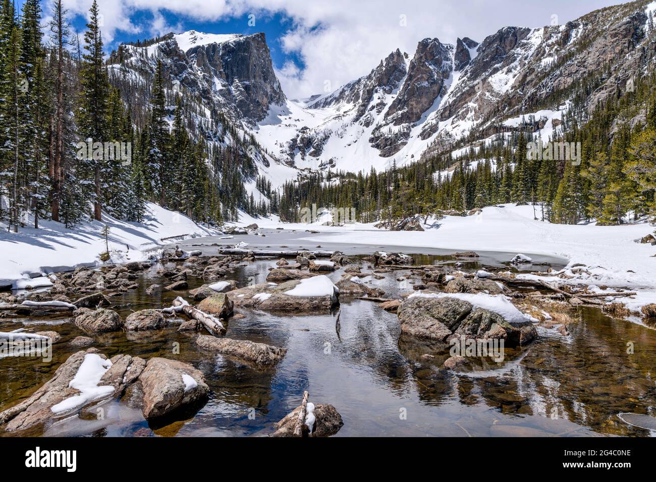 Spring Mountains - Panoramic Spring view of Hallett Peak and Flattop Mountain at still-mostly-frozen Dream Lake, Rocky Mountain National Park, CO, USA. Stock Photo