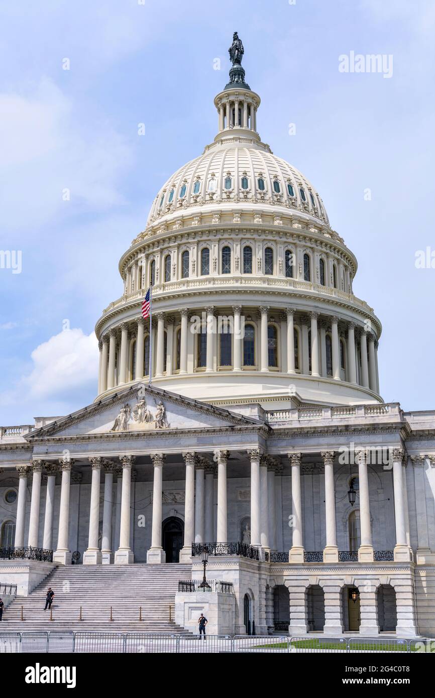 The Capitol Building - Close-up vertical view of east facade of the U.S. Capitol Building, with security officers standing at front of entrance. Stock Photo