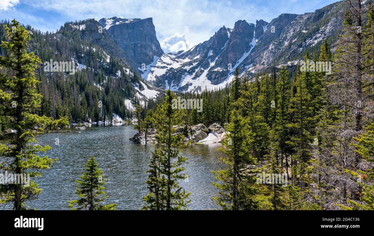 Spring Mountains - A Spring panoramic view of Hallett Peak and Flattop Mountain towering at shore of Dream Lake, Rocky Mountain National Park, CO, USA. Stock Photo