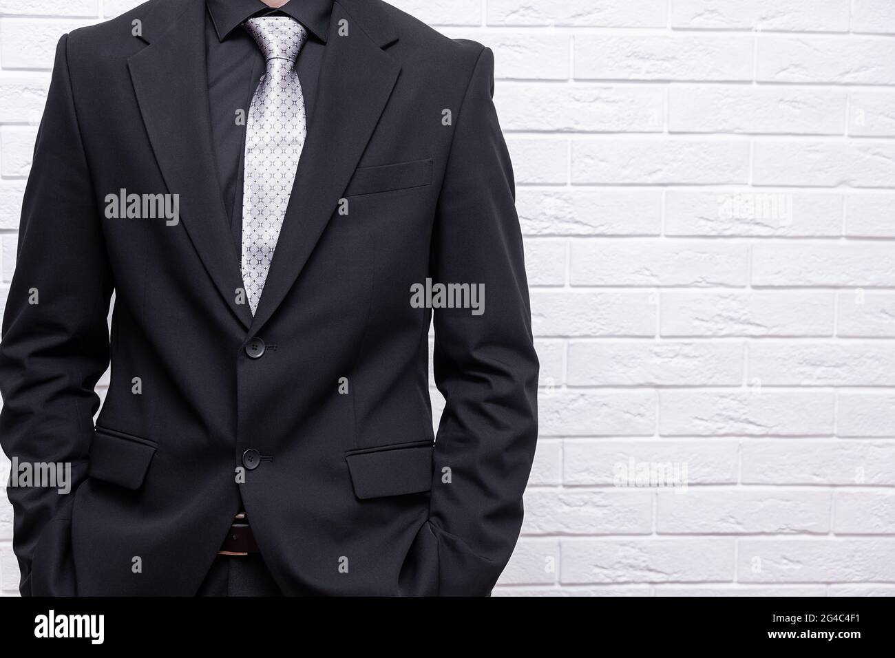 Handsome confident businessman wearing suit standing isolated over ...