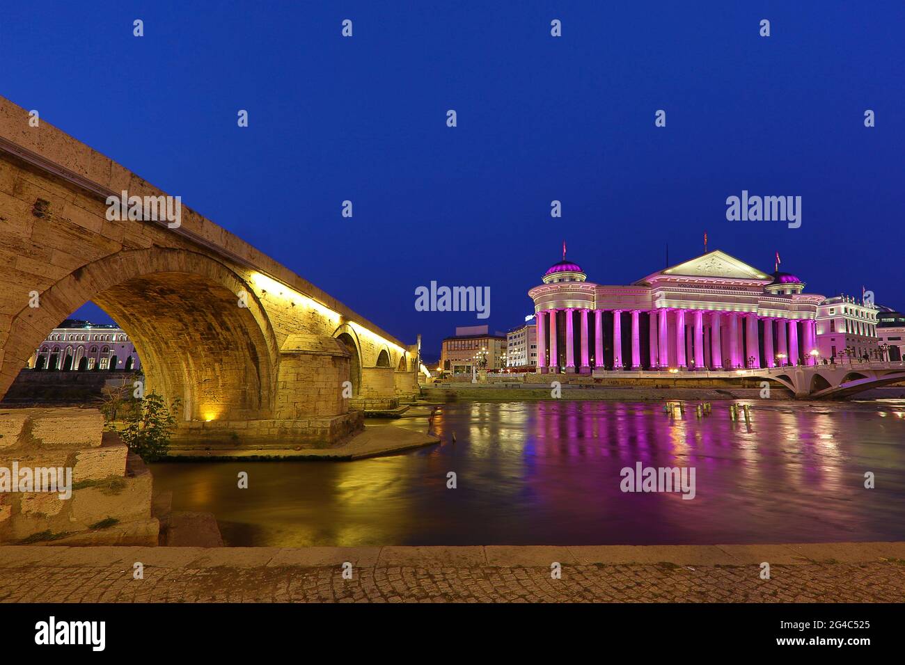 Historical stone bridge and Archaeological Museum building on the Vardar River in Skopje, North Macedonia Stock Photo
