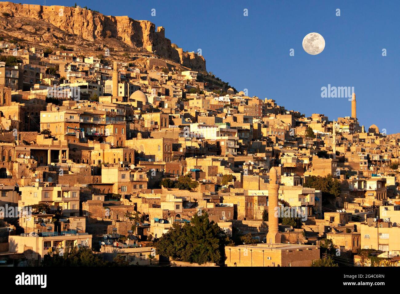 View over the old city of Mardin with full moon in the sky, Turkey. Stock Photo