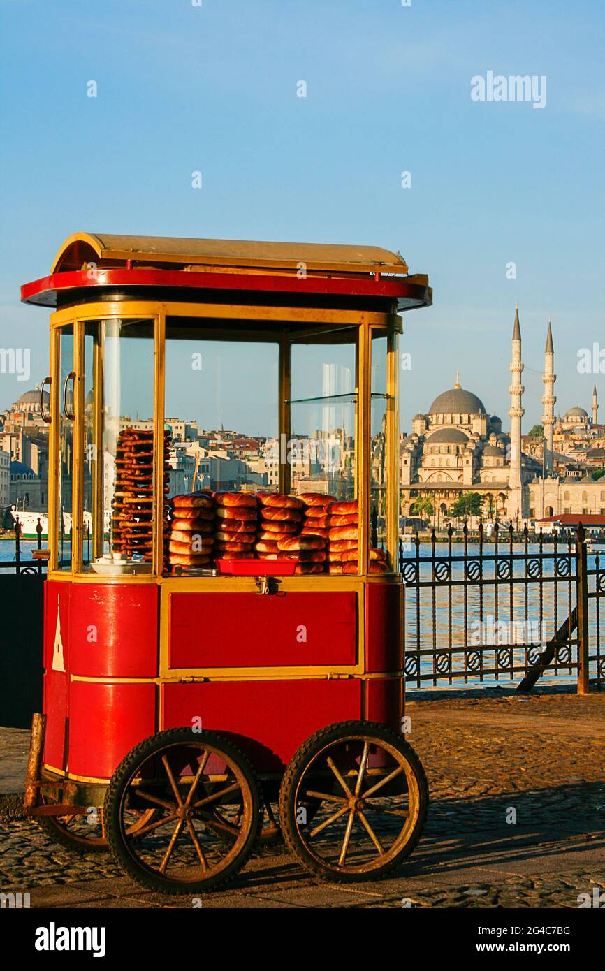 Cart with Turkish bagels known as Simit with the skyline of Istanbul, Turkey Stock Photo
