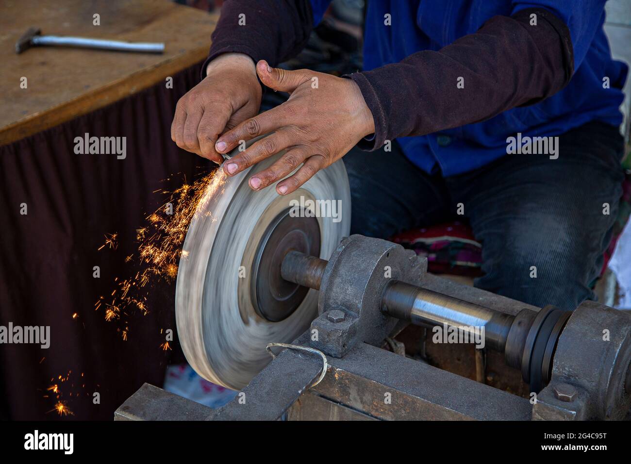 Sharpening the knife and scattered sparks. Stock Photo