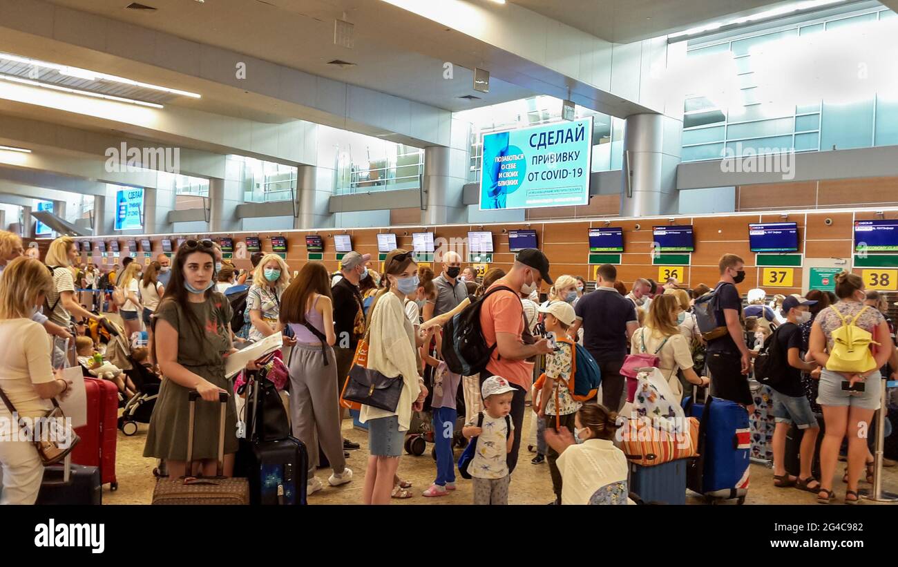 Moscow, Russian Airport Sheremetyevo people crowded in Aeroflot check in area.  Blue sign (in Russian) vaccination campaign: Vaccinate against COVID Stock Photo