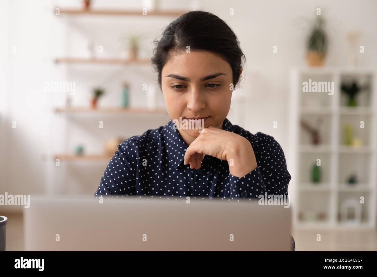 Pensive Indian woman work on computer thinking Stock Photo - Alamy