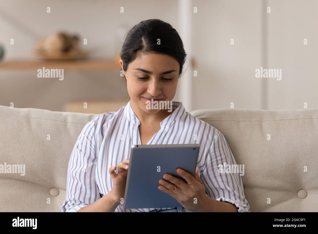 Happy Indian woman use tablet speak on webcam call Stock Photo - Alamy
