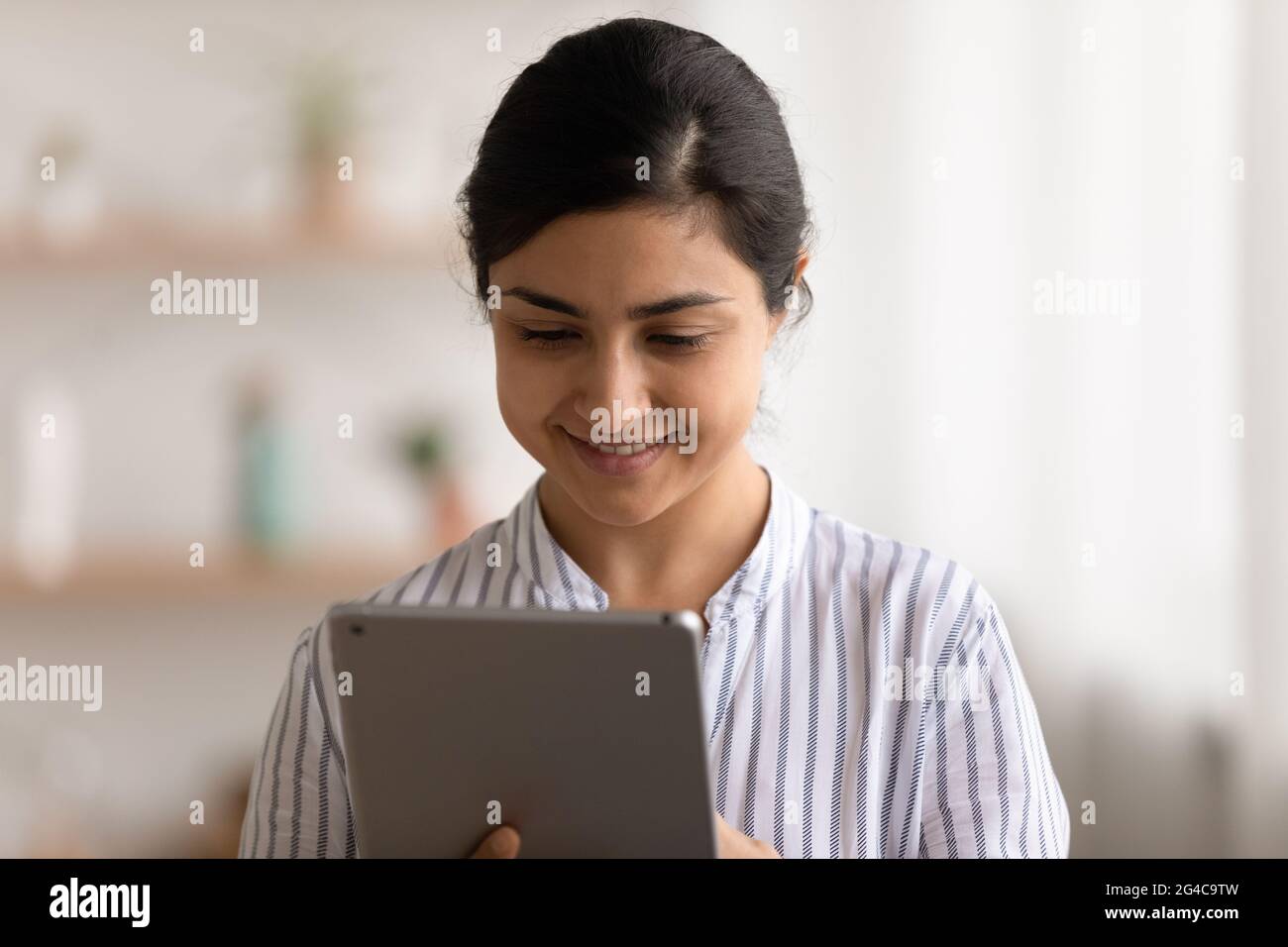 Happy Indian woman use tablet browsing Stock Photo Alamy