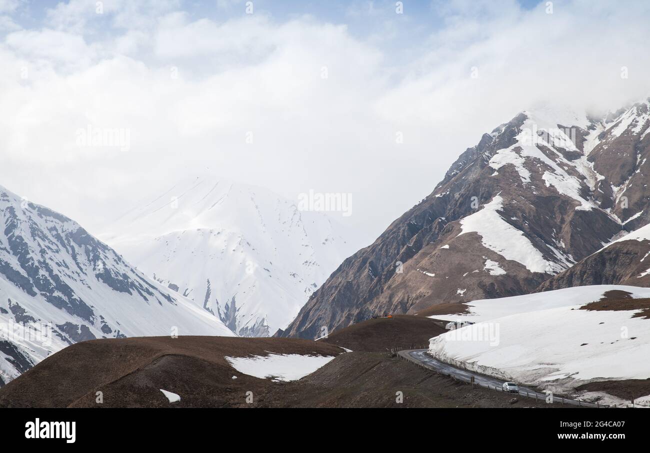 Landscape of Caucasus Mountains with snowy peaks on a daytime. Gudauri, Georgia Stock Photo