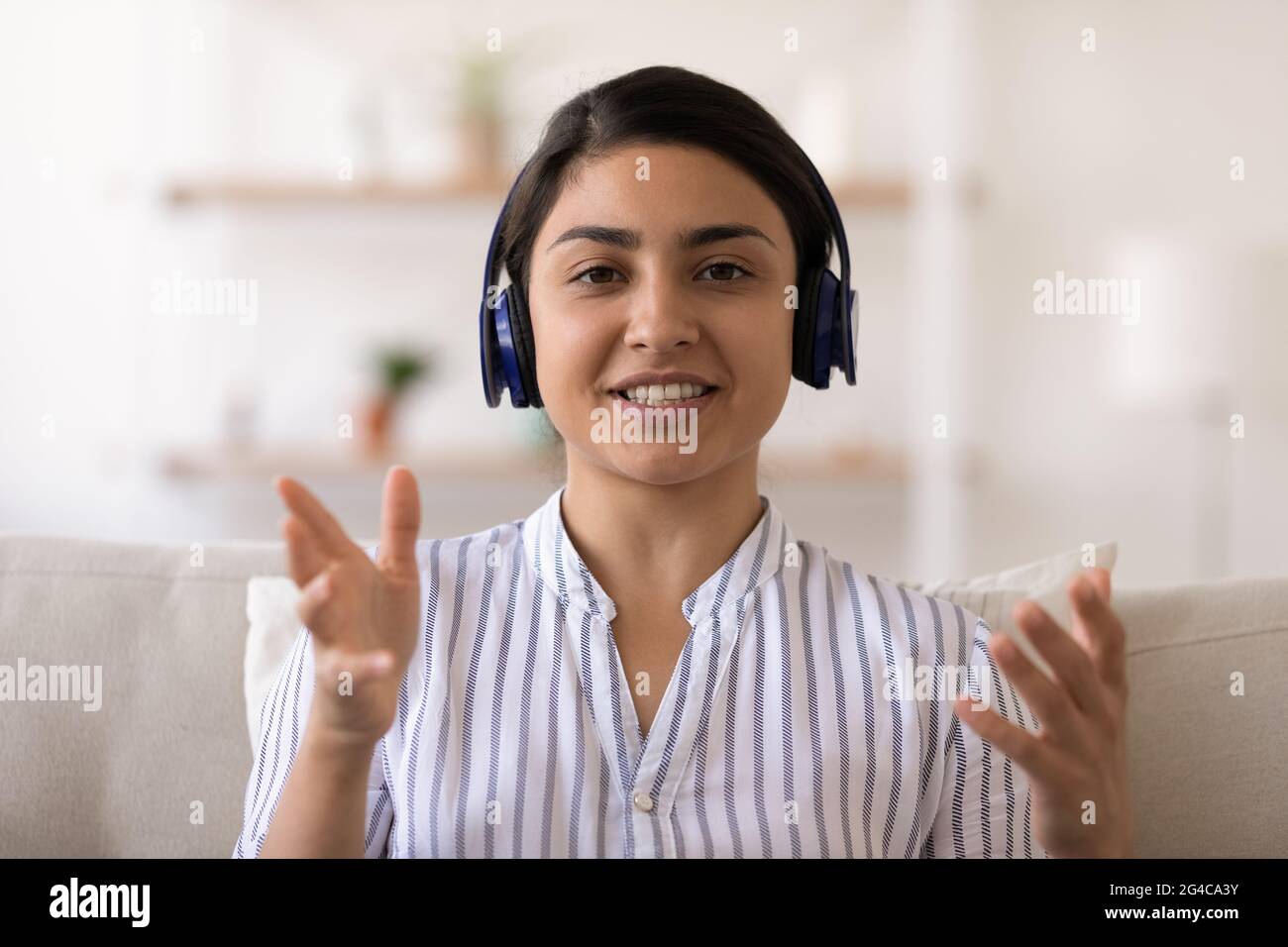 Portrait of Indian woman in headphones talk on video call Stock Photo ...
