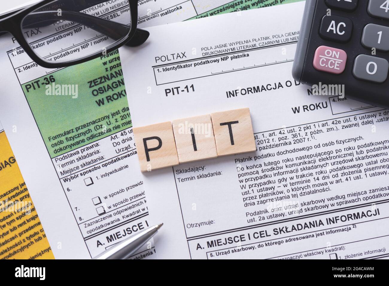 Tax income concept with polish tax forms and PIT word from tiles, means personal tax income in Poland Stock Photo
